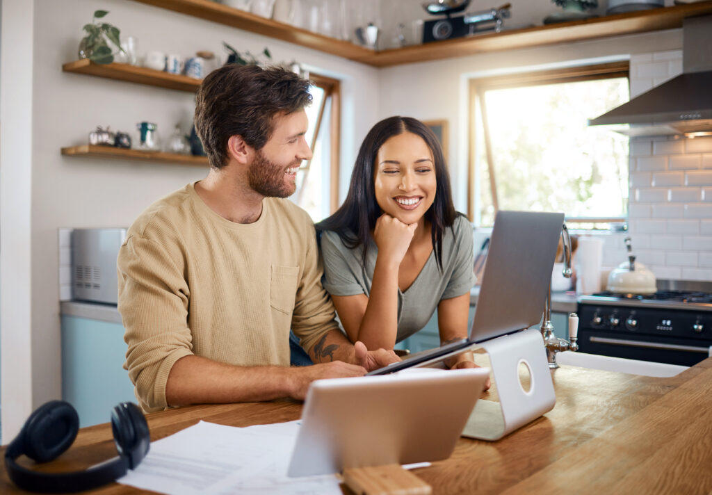 Happy couple analyzing their savings growth with Amerant Bank using a long-term CD