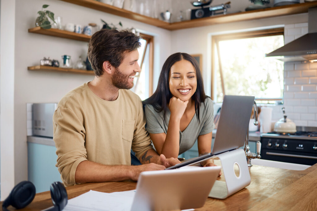 Happy couple analyzing their savings growth with Amerant Bank