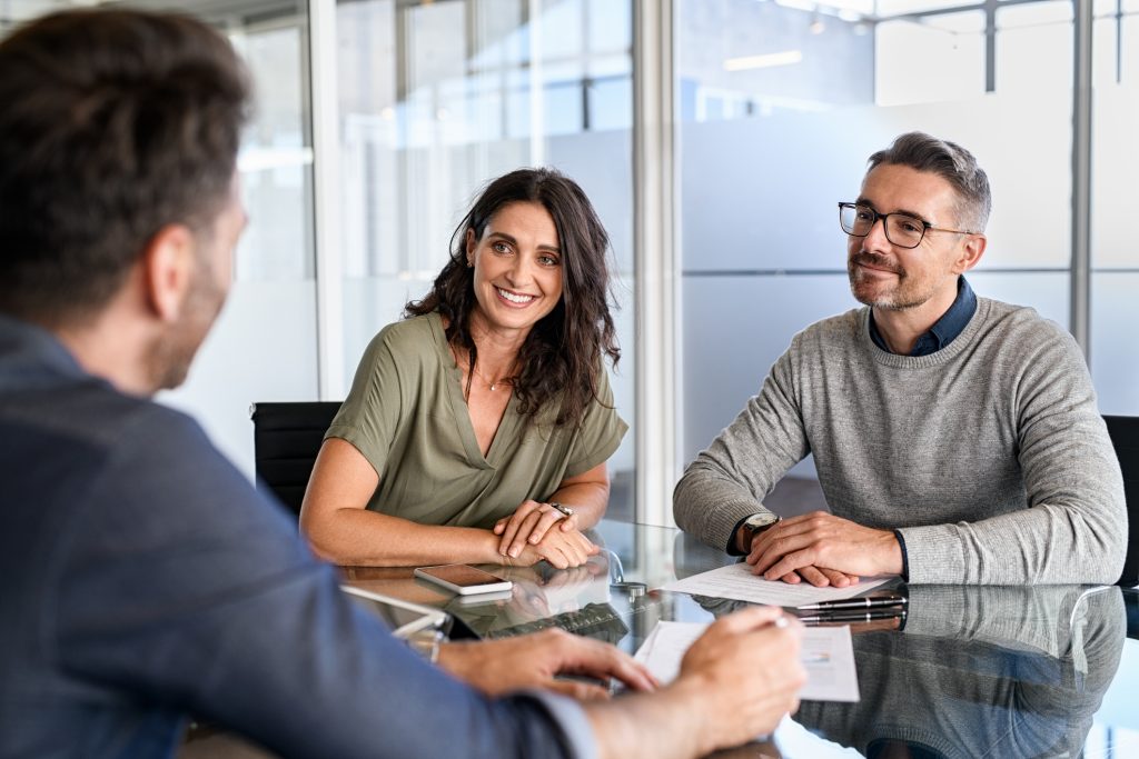 couple comparing secured loan vs. unsecured loan with an Amerant team member