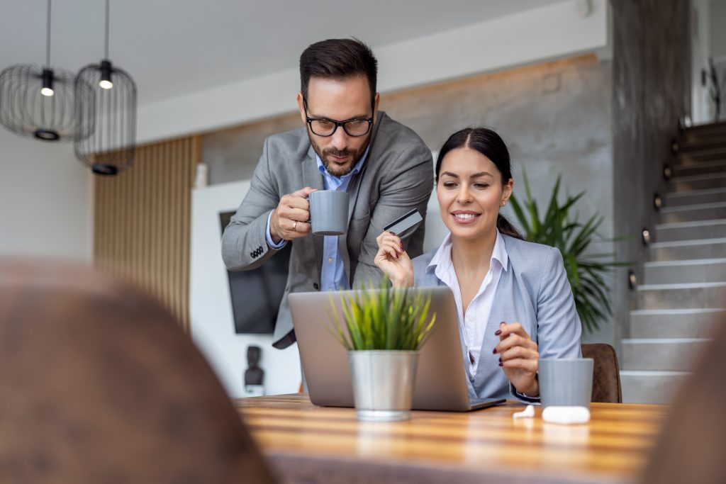 Two business people sitting together discussing the benefits of a business card