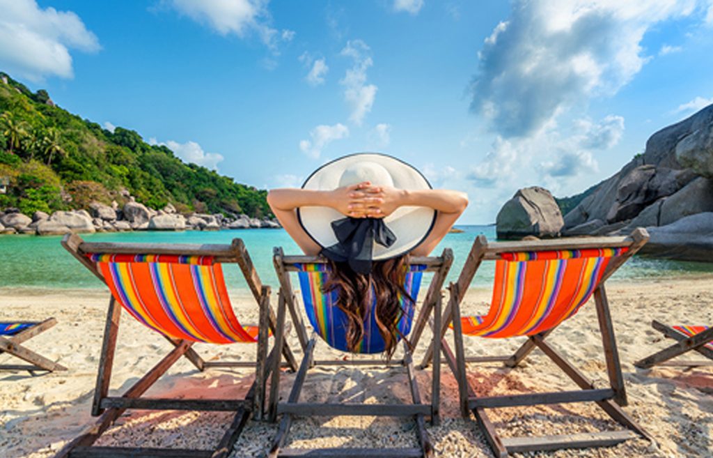 Woman on vacation relaxing because her personal and financial information is secure with travel safety tips