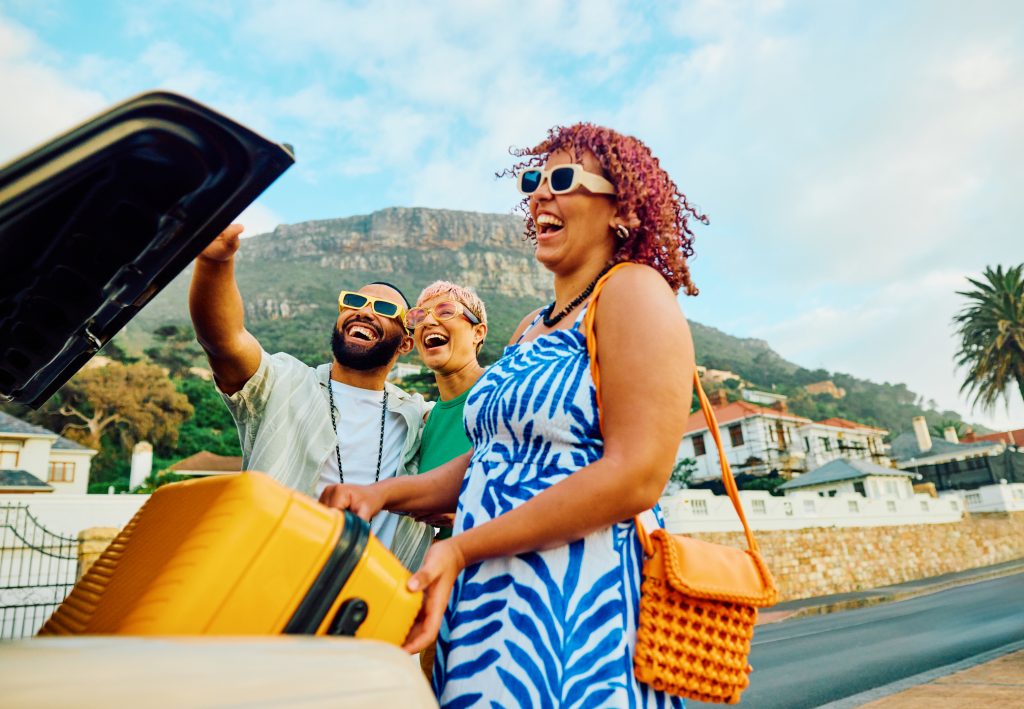 Family taking a selfie picture during their summer vacation after using budget tips