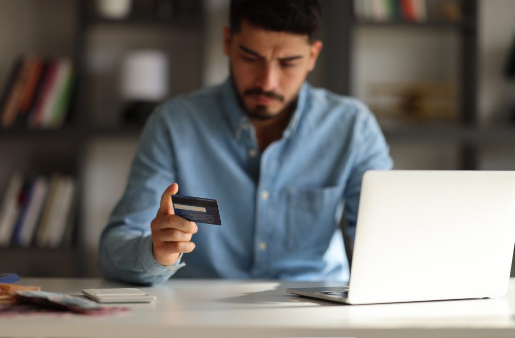 man attempting to avoid scams and protct your identity with amerant bank