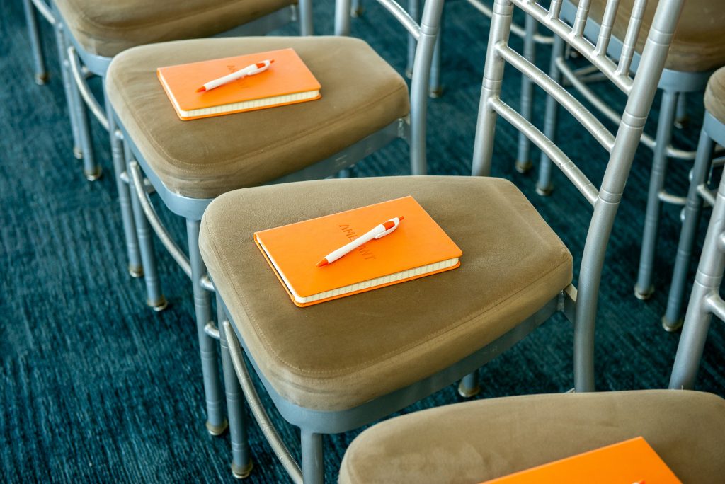 amerant bank notebooks laid on chairs of attendees for investment strategies event
