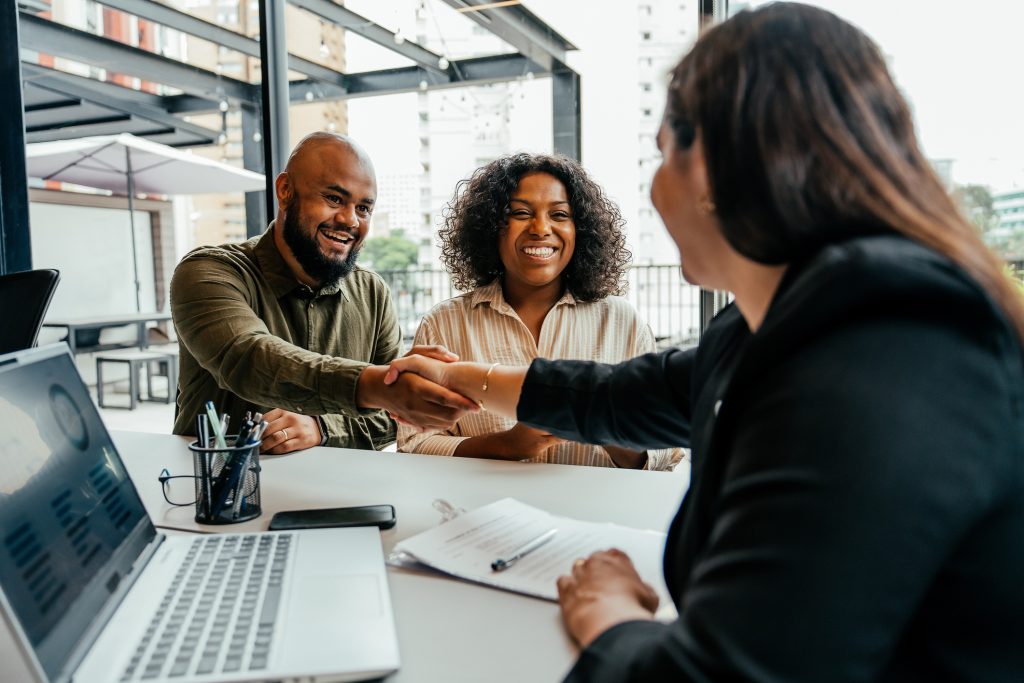 clients speaking to banker while shaking hands about Deposit Escrow Sub-Accounting Solutions