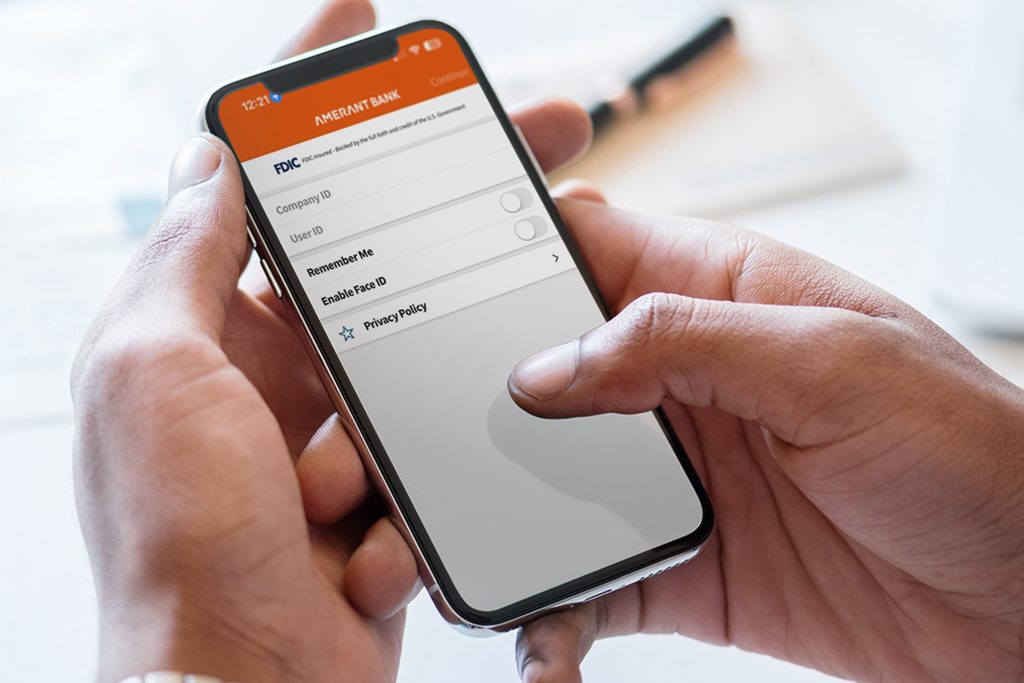 Person's hands are using the iphone to login to TreasuryConnect and use Open Access Connect tool